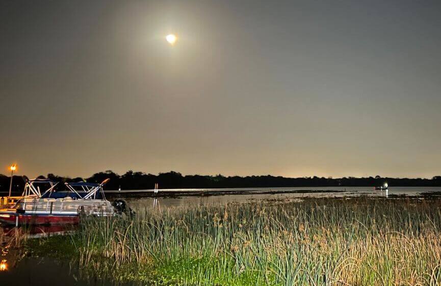 A night
    shot of Lake Seminole taken by the Pinellas County Sheriff, full moon
    in the background.